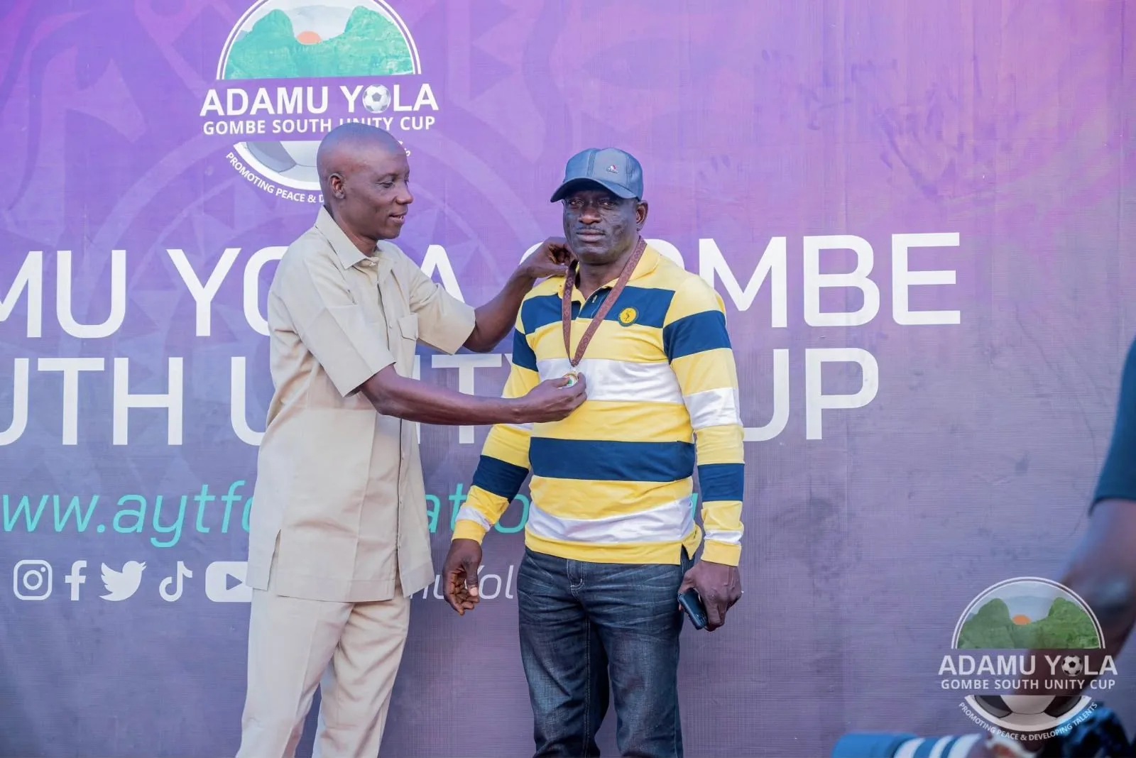 A Unity Cup volunteer receives a medal